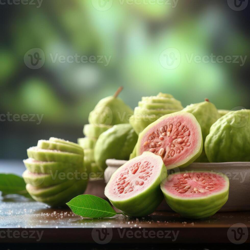 A bowl of sliced guavas with a few whole ones on top. photo