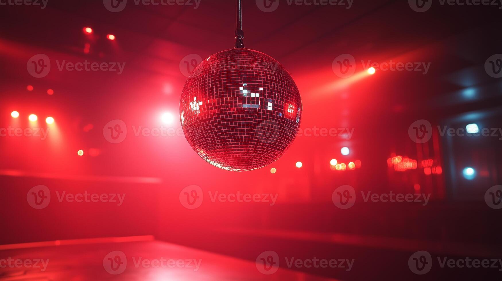 A disco ball hanging from a ceiling in a dark room photo