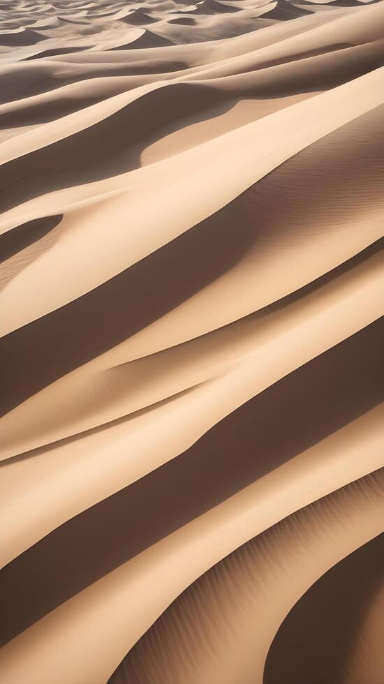 A high-detail image of sand dune patterns, highlighting the smooth curves and subtle shadow play across the surface. photo