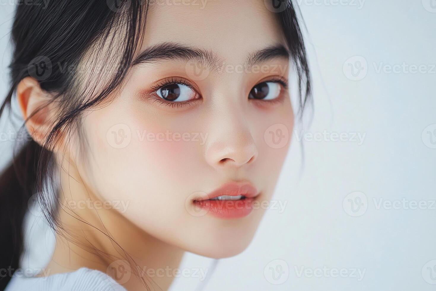 A beautiful young woman with long hair and a white shirt photo