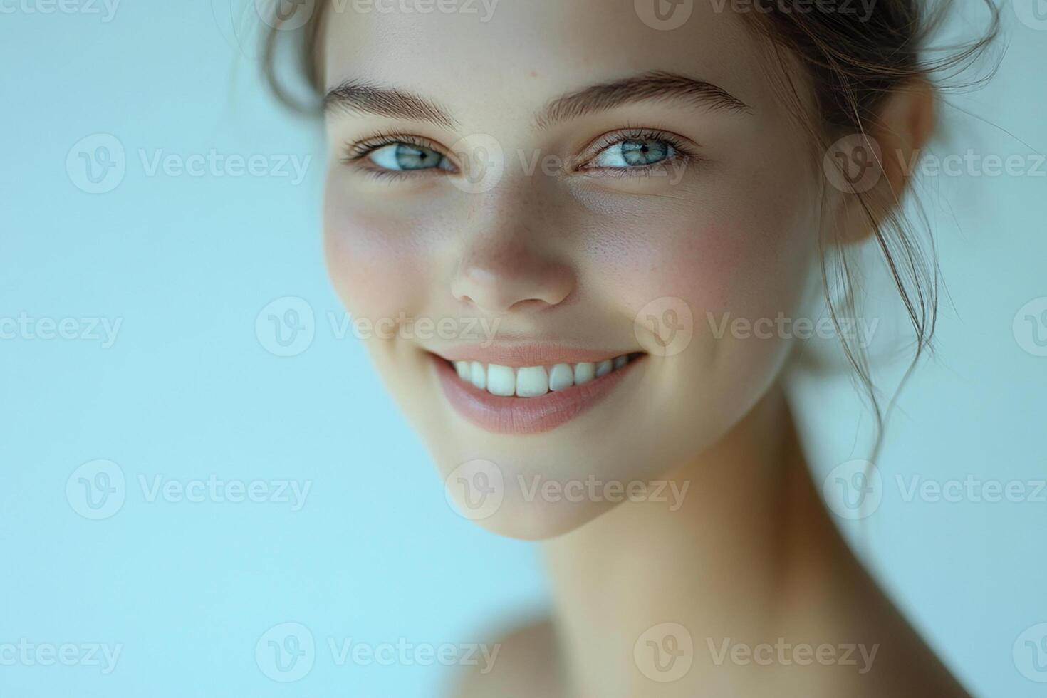 Beautiful young woman with blue eyes smiling photo