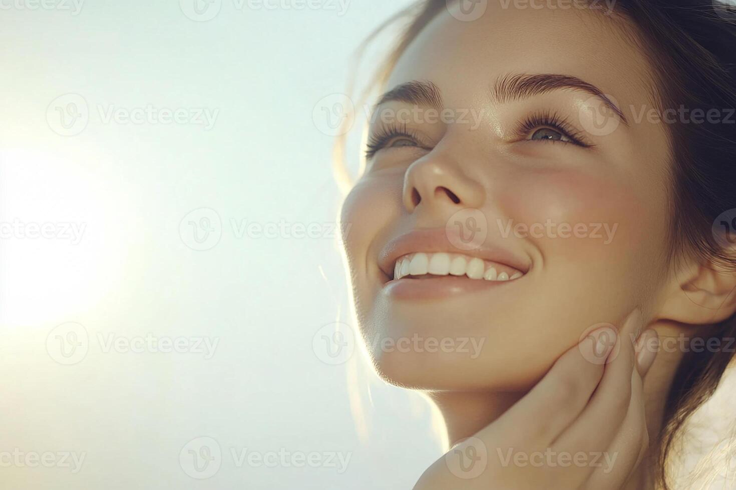 A woman smiling with her hands on her face photo
