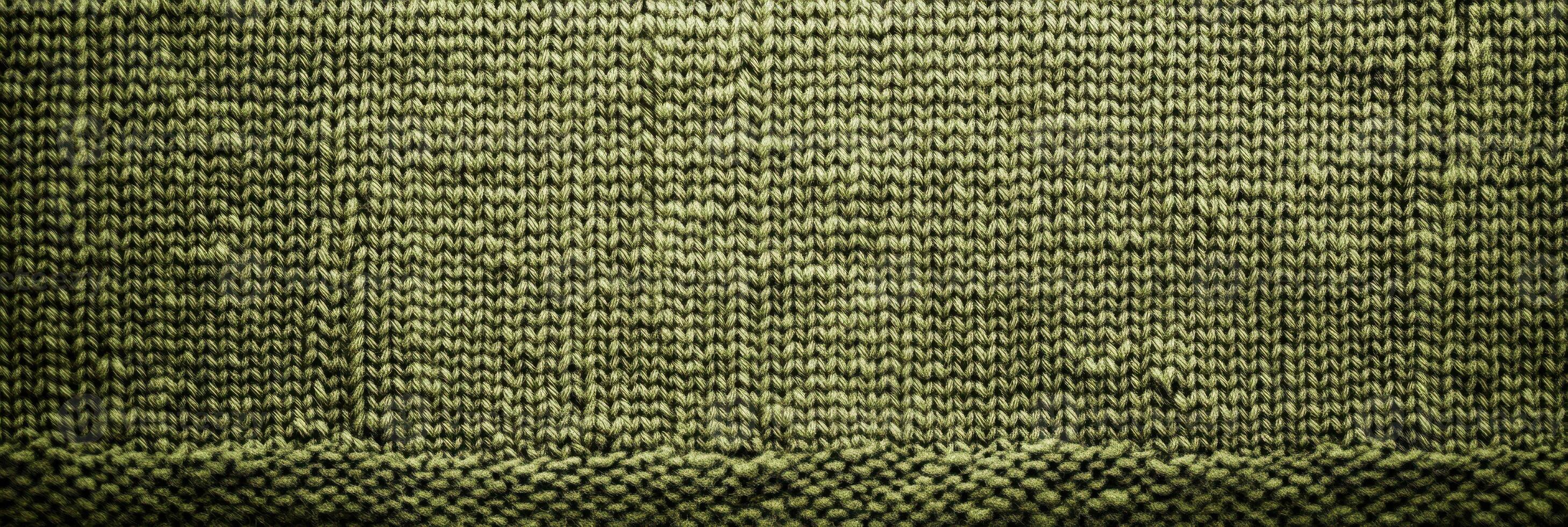 Closeup of green knitted fabric with textured pattern and detailed stitches photo