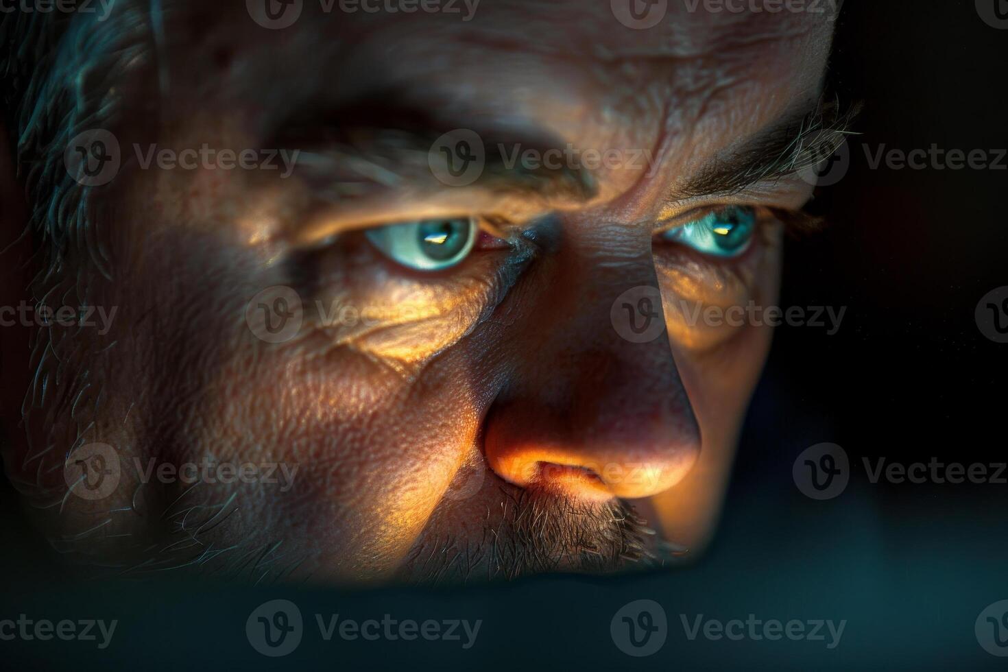 A man staring at the screen of a computer photo