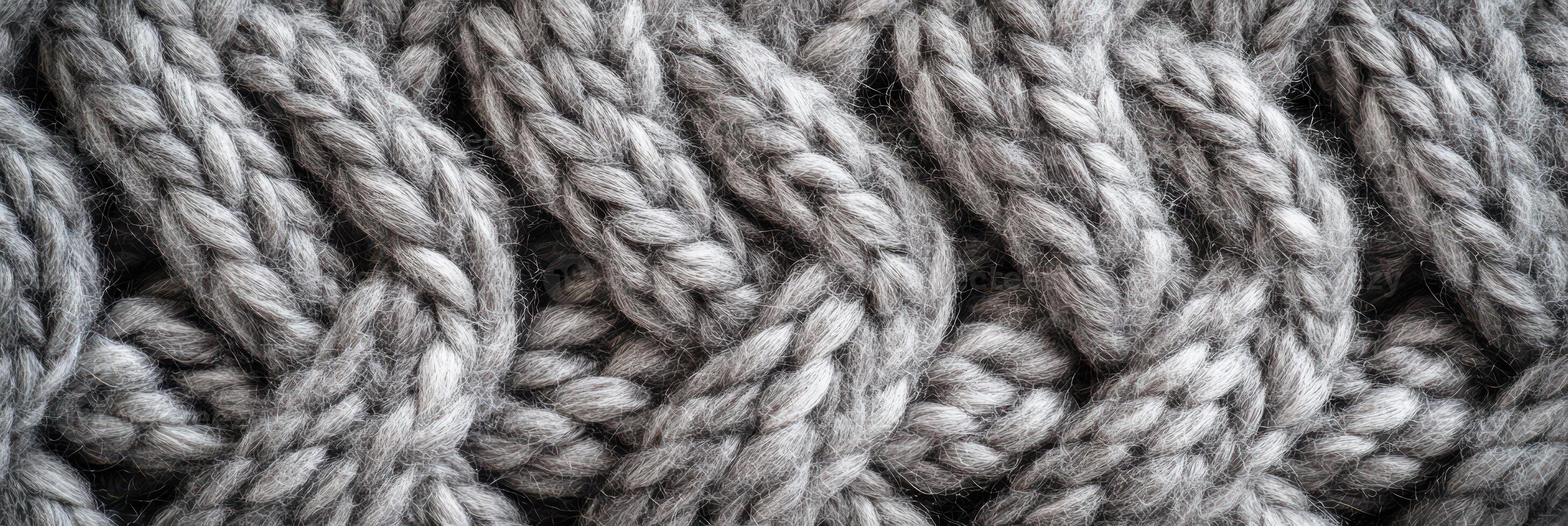 Close-up of textured gray wool pattern with braided knitting design photo