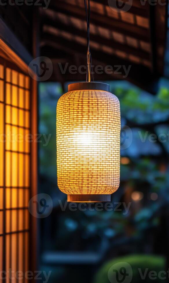 Illuminated woven lantern casts a warm inviting glow on a peaceful oriental setting scene photo