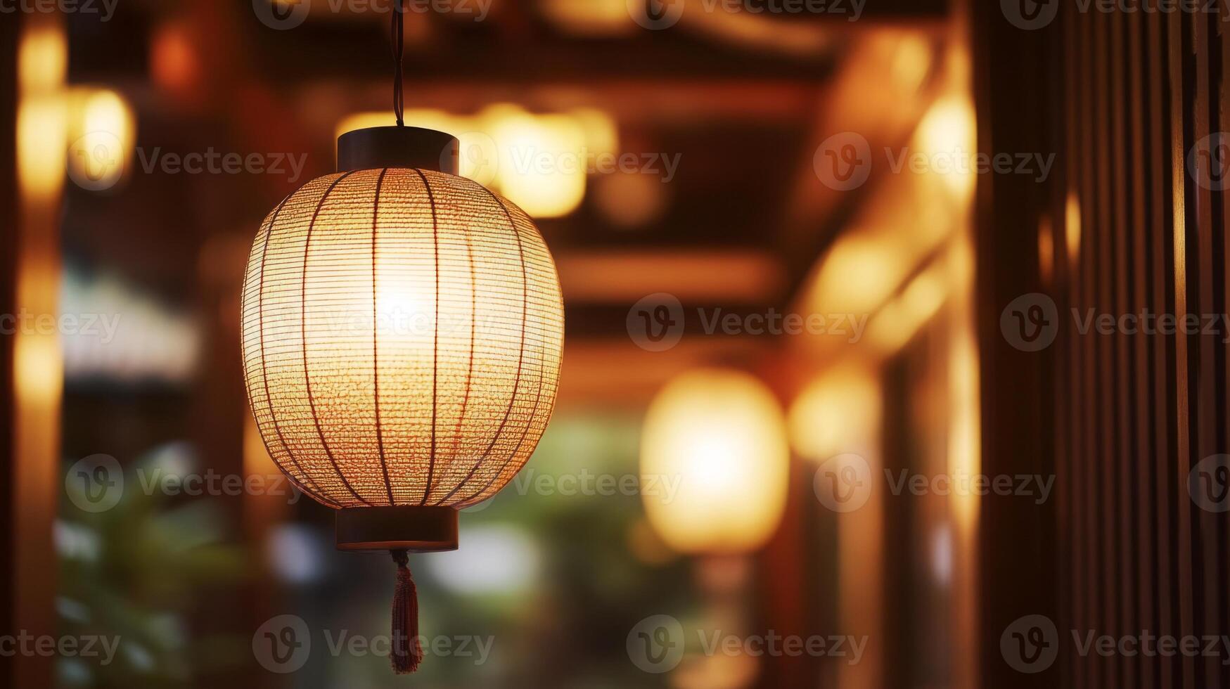 Illuminated asian paper lantern casting a warm inviting glow in a traditional setting photo