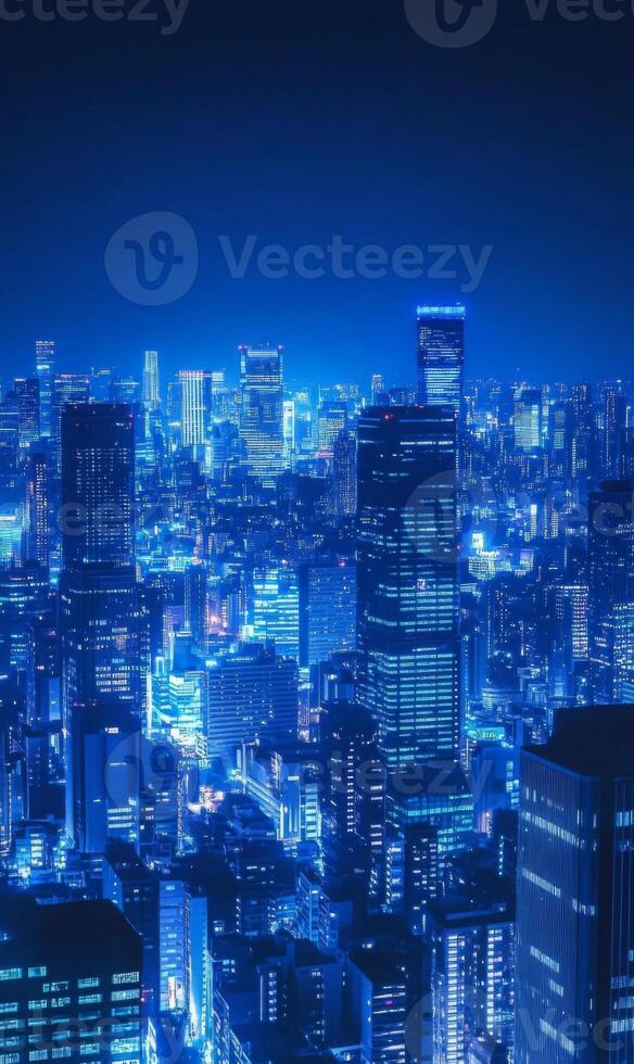 Electric blue cityscape at night with towering structures and glimmering illumination display photo