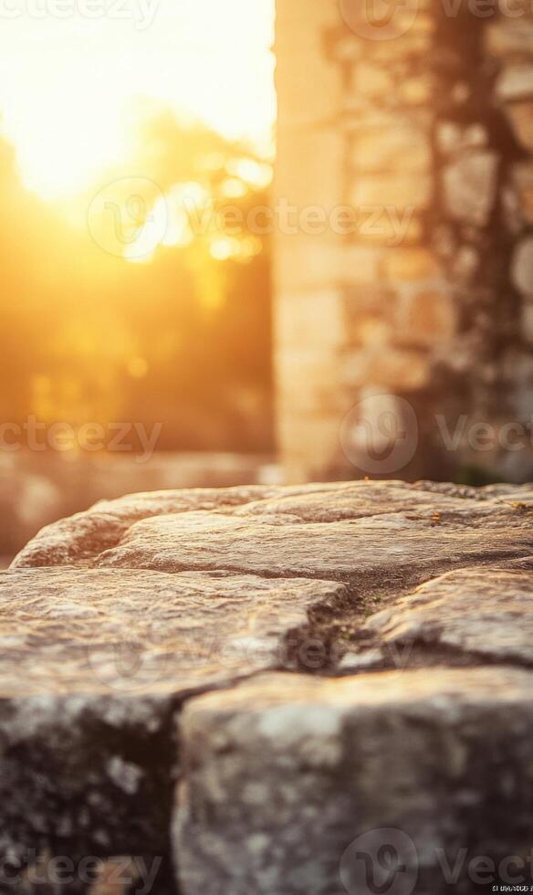Sun kissed stone platform with blurred ancient architecture backdrop illuminates warmth and texture photo