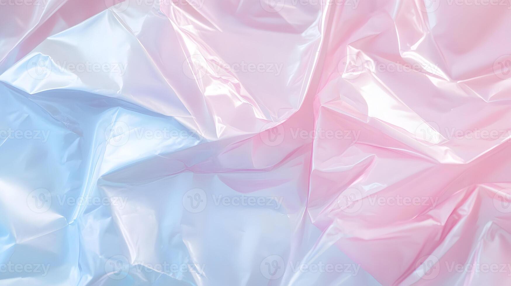 Iridescent polyethylene sheet with crumpled texture reflecting pastel pink and blue hues photo