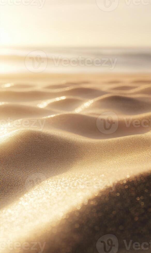 Golden hour kisses the tranquil beach sand creating small undulating waves near the ocean photo
