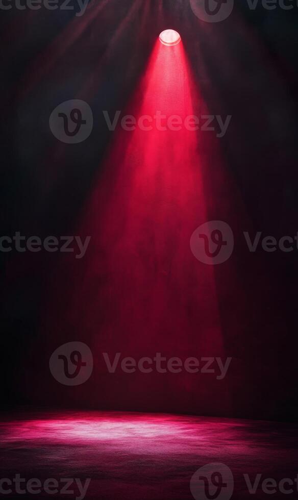 Illuminated stage with a singular red spotlight piercing through atmospheric haze and darkness photo