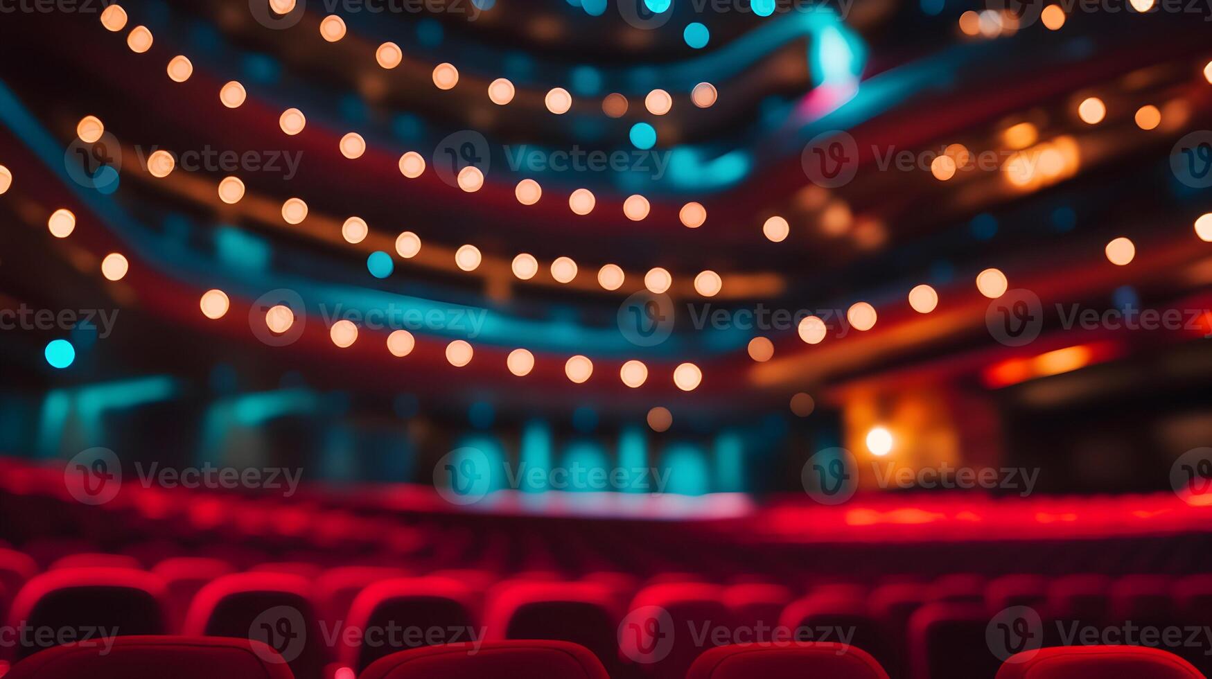 Blurred theater interior with illuminated stage and rows of plush red seats background photo