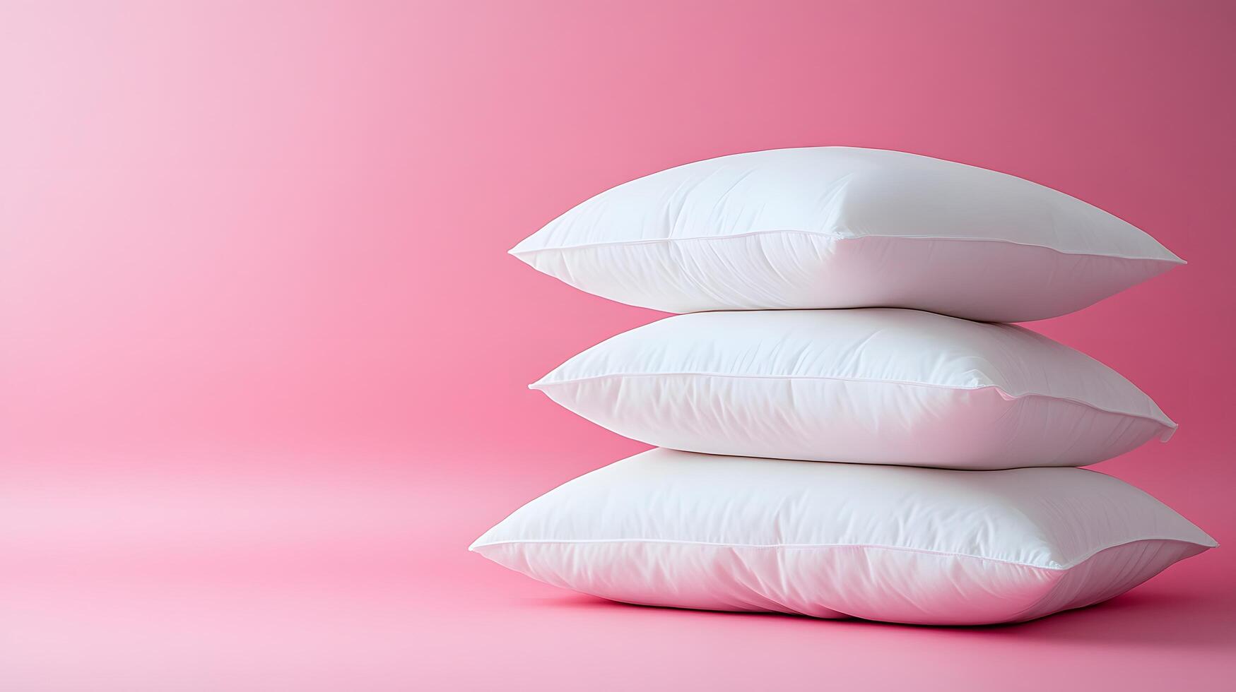 Pure white fluffy pillows stacked against soft pink background create minimalist composition with right-side positioning, emphasizing textile textures and comfort. bedroom photo