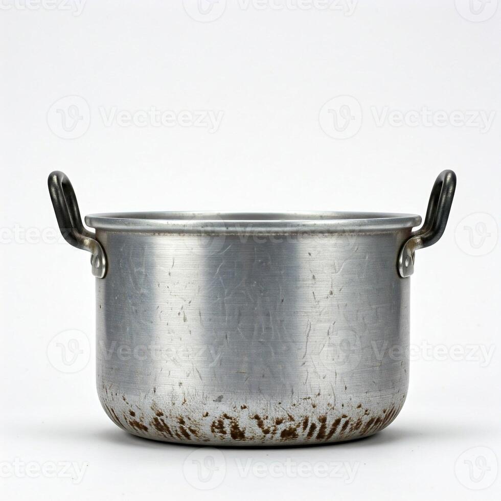An old metal pot with handles on a white background photo
