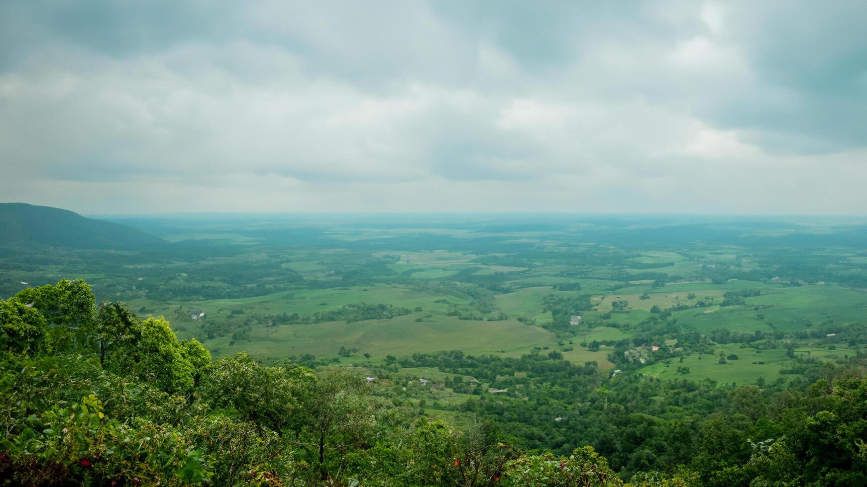 Mountaintop view green valley, cloudy sky, rural landscape photo