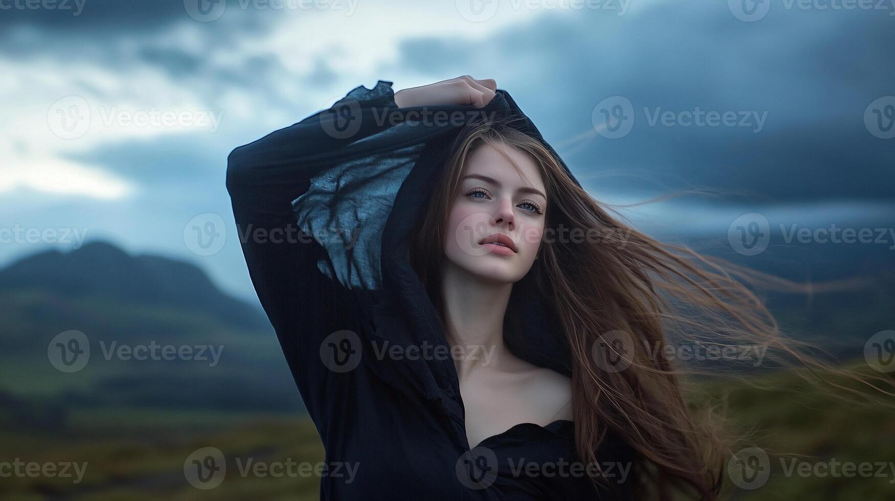 Woman in black dress, windy landscape, dramatic sky, portrait, possible use for fashion or nature photo