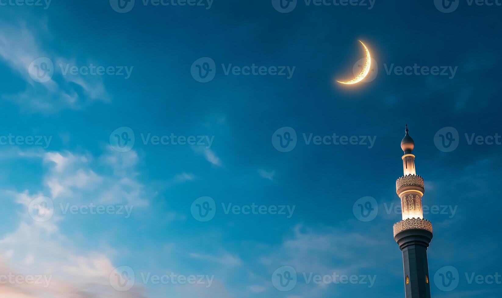 Crescent moon over mosque at night photo