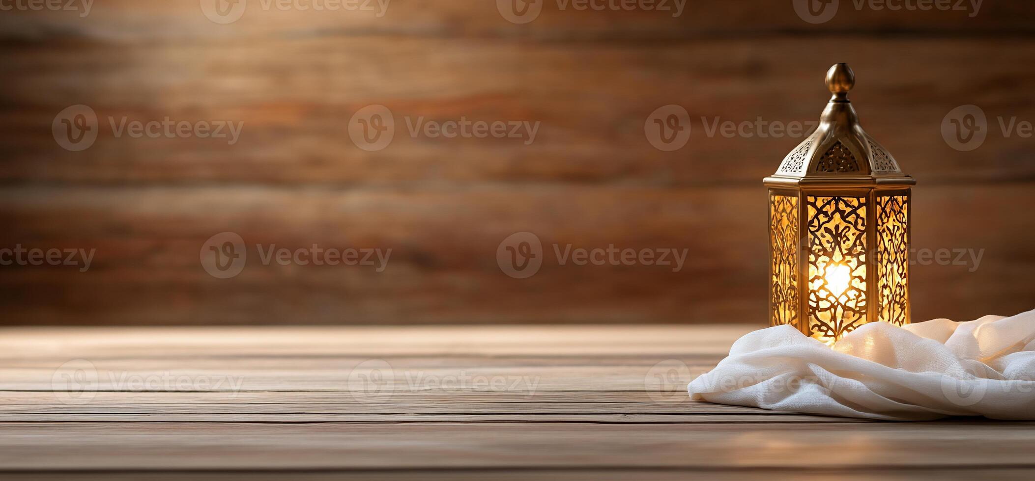 Illuminated lantern on wooden table, fabric, background. Ramadan photo
