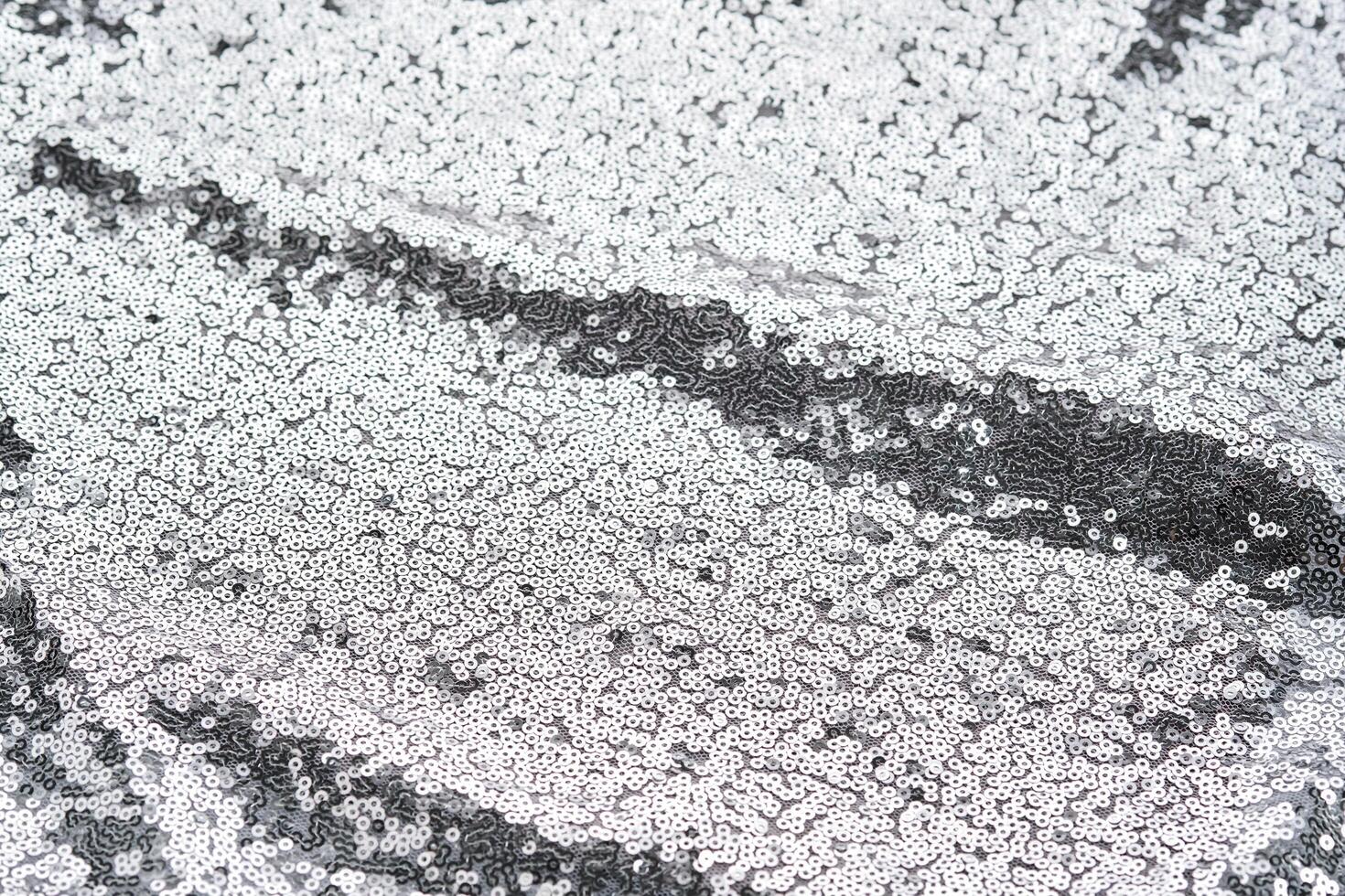 Abstract festive fabric texture with silver sequins. photo