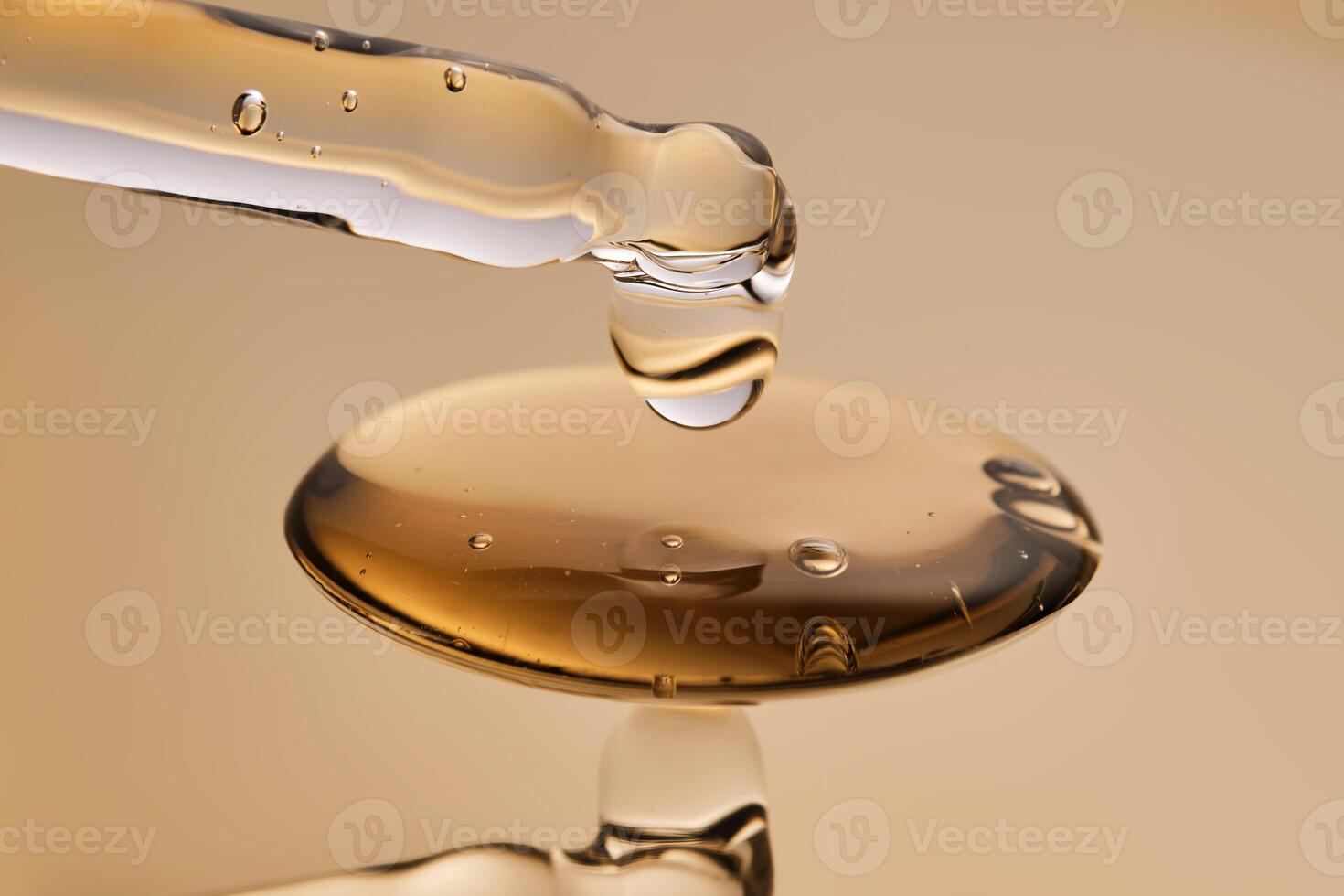 A pipette with a beautiful drop of gel-textured facial serum. photo
