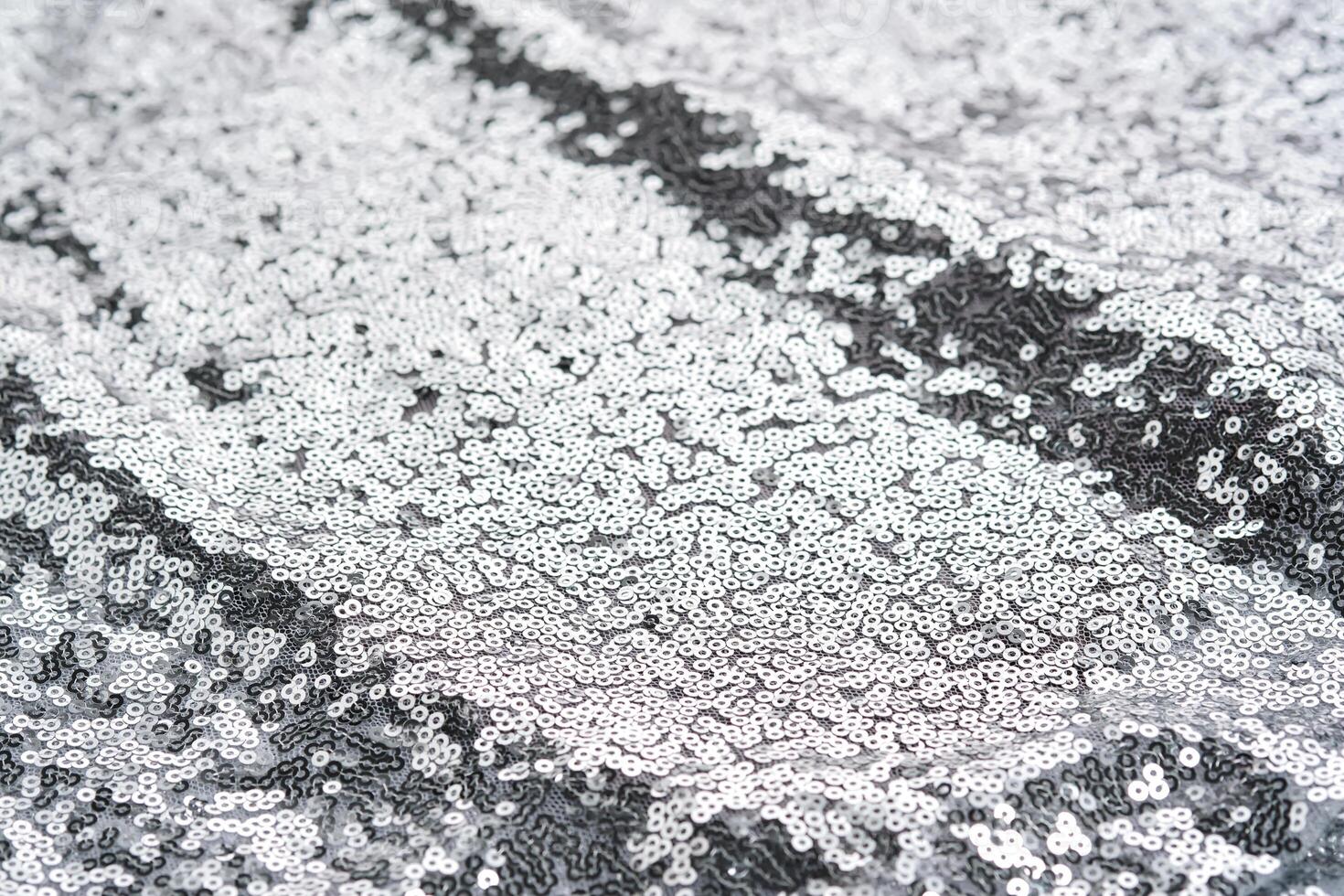 Abstract festive fabric texture with silver sequins. photo