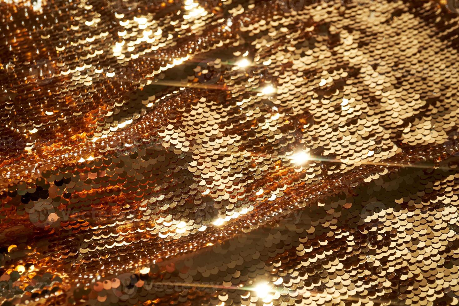 Abstract festive gold background made of sequins. photo