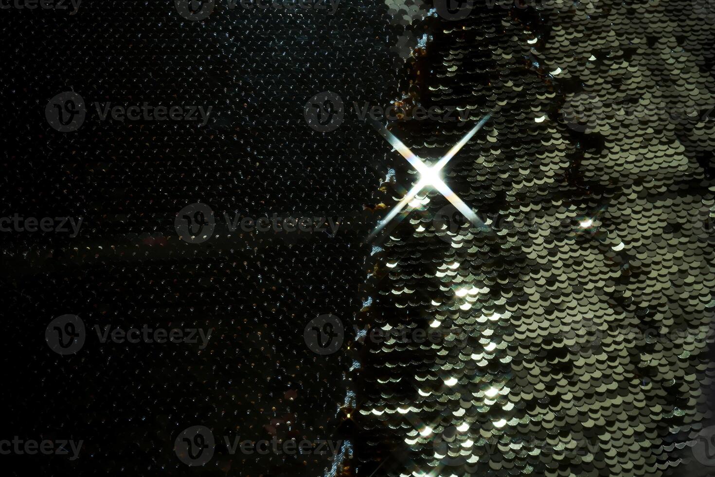 Abstract festive dark background made of sequins. photo