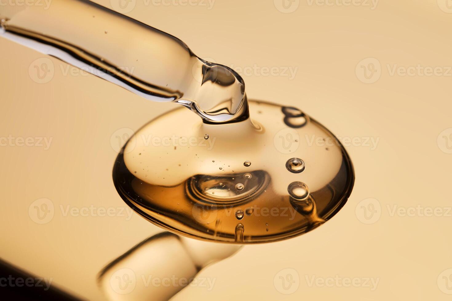 A pipette with a beautiful drop of gel-textured facial serum. photo