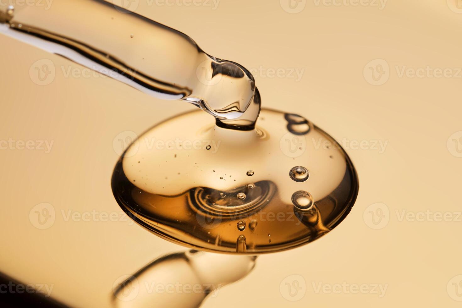 A pipette with a beautiful drop of gel-textured facial serum. photo