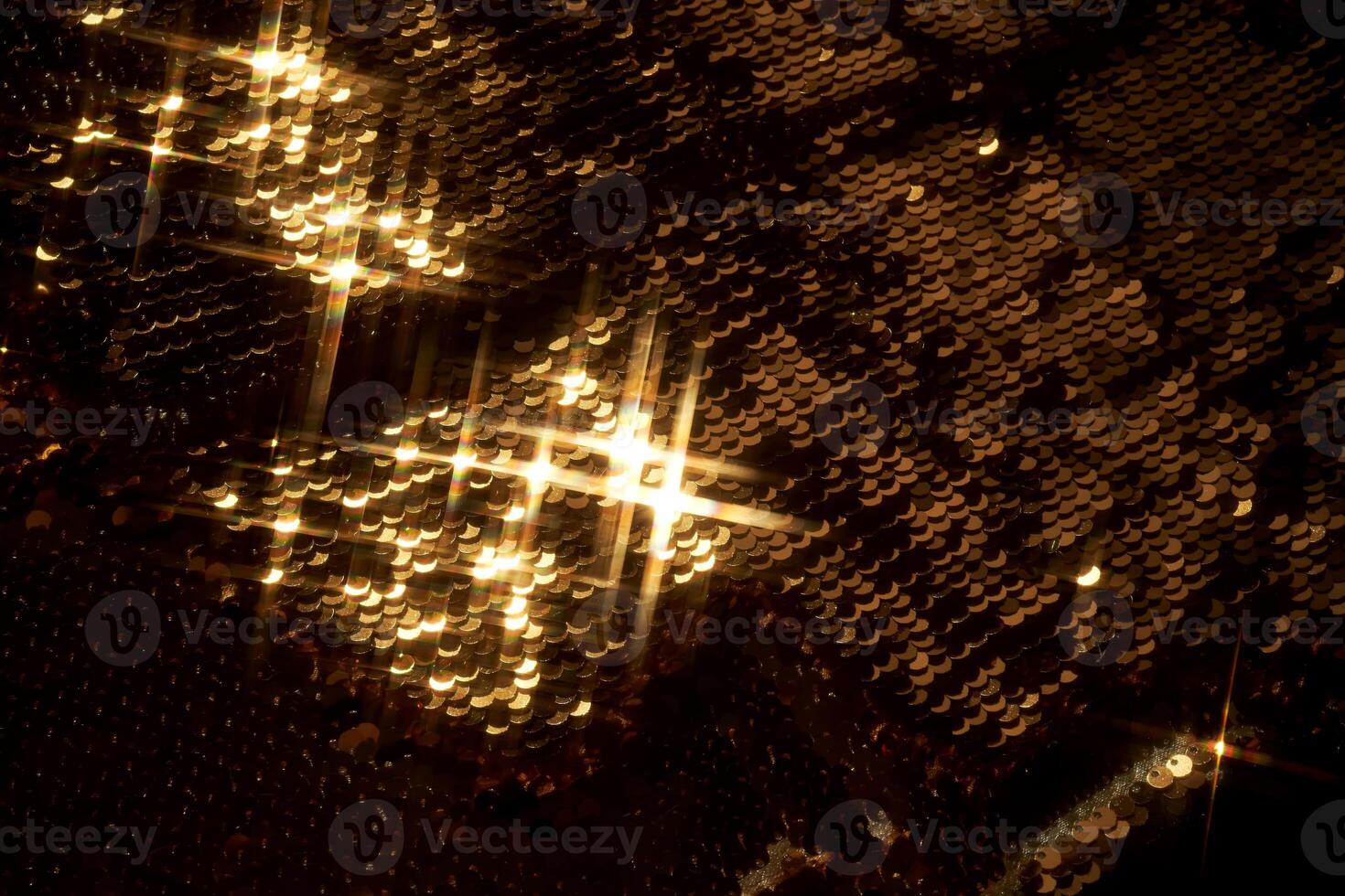 Abstract festive gold background made of sequins. photo