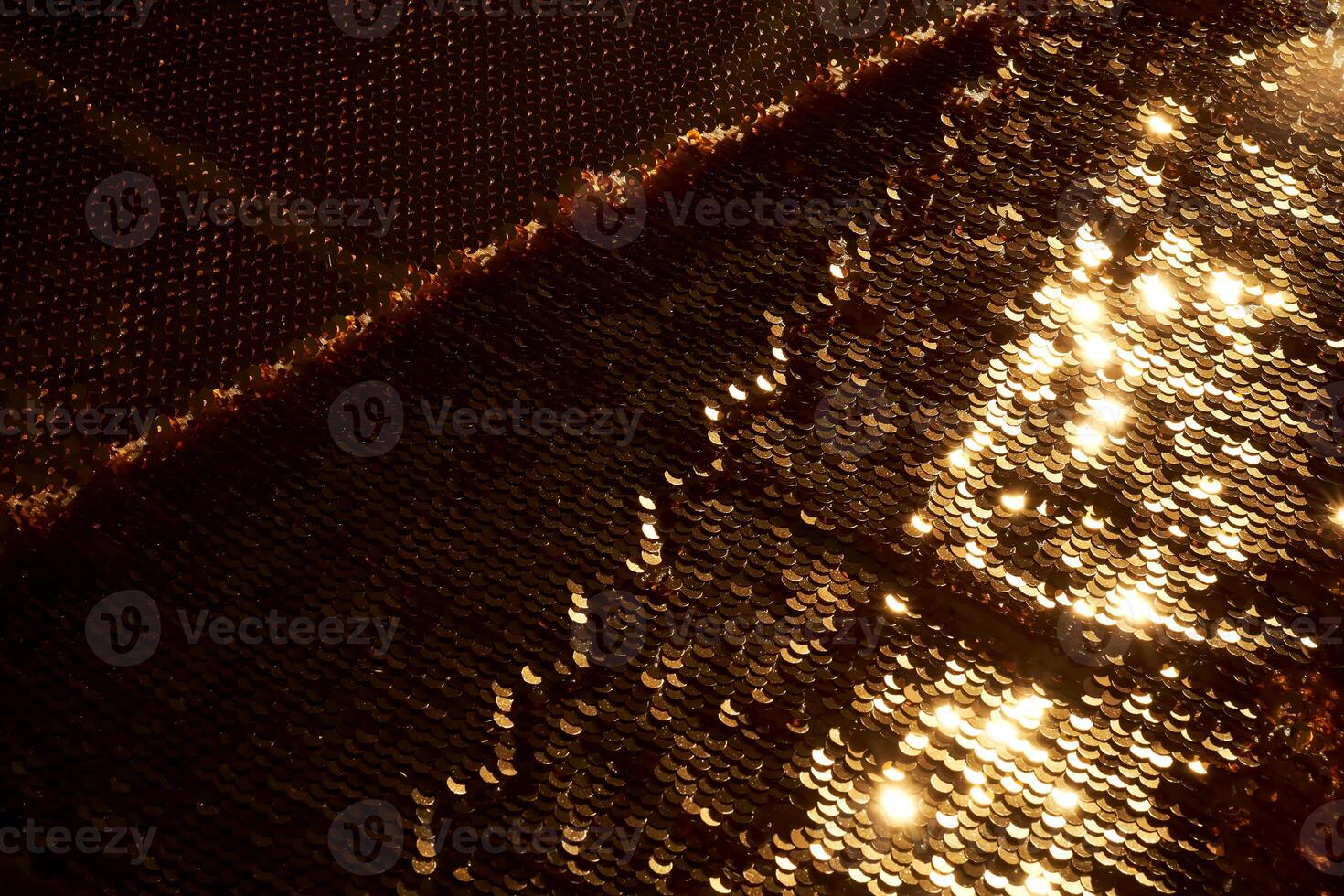 Abstract festive gold background made of sequins. photo
