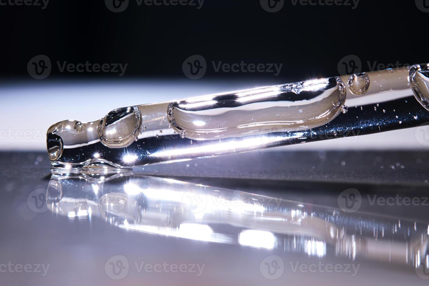 A serum pipette on a dark background. photo