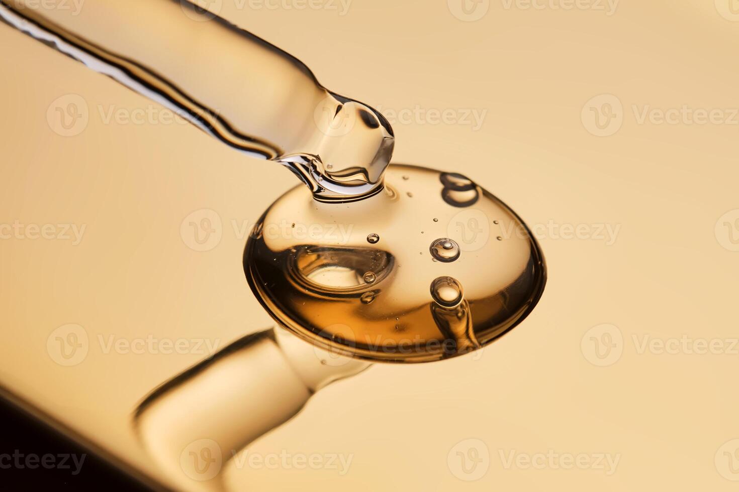 A pipette with a beautiful drop of gel-textured facial serum. photo