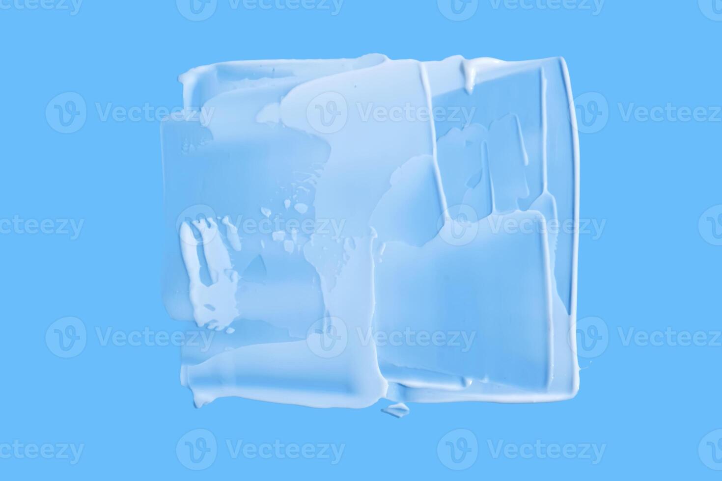 A smear of white cream in the shape of a square on a blue background. photo