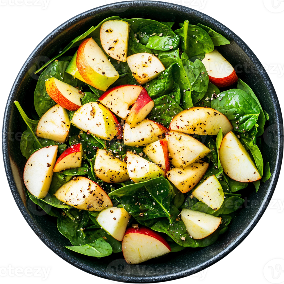Apple spinach salad with pepper seasoning in black bowl png