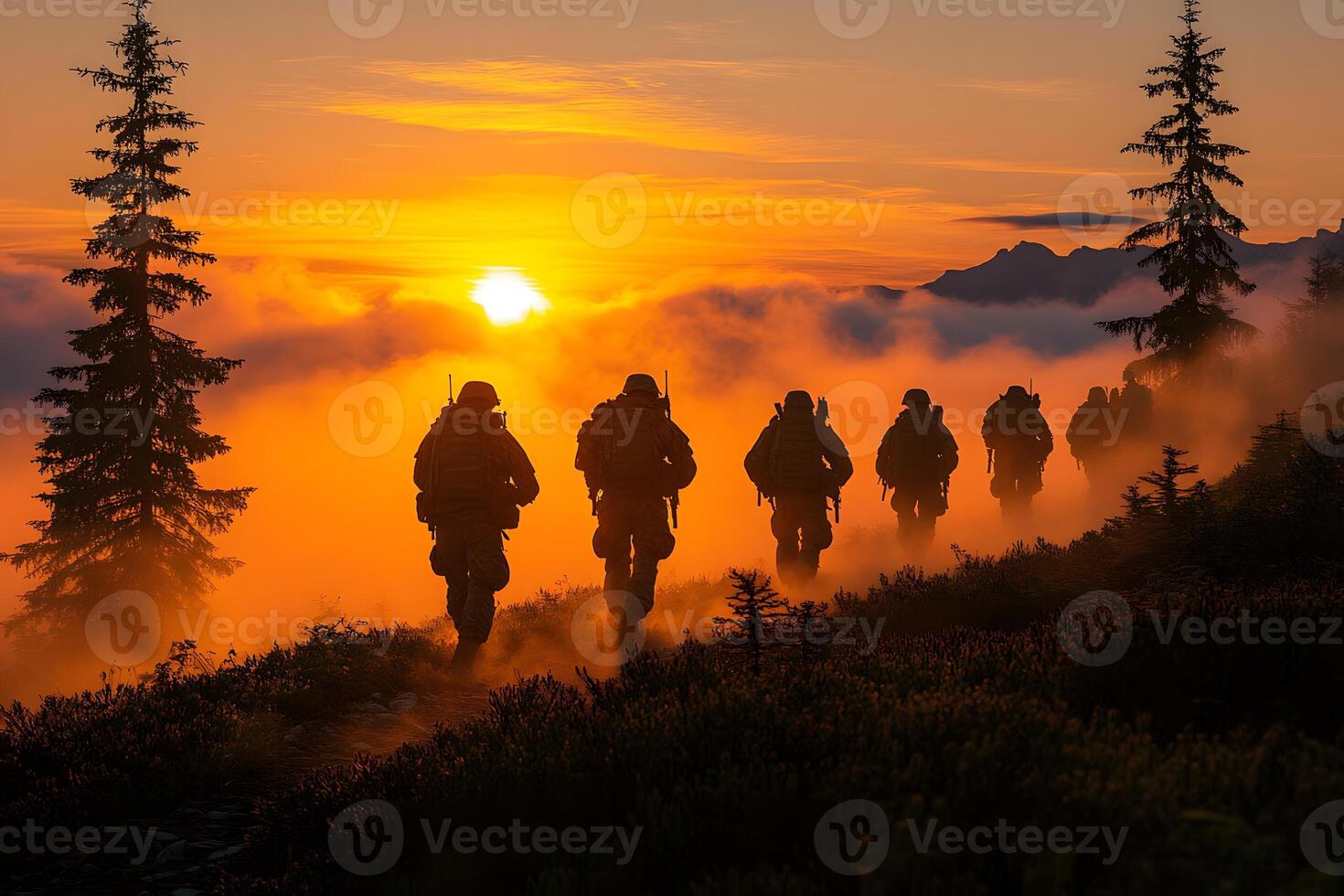 Sunset Silhouette of Soldiers Hiking through Misty Mountain Landscape photo