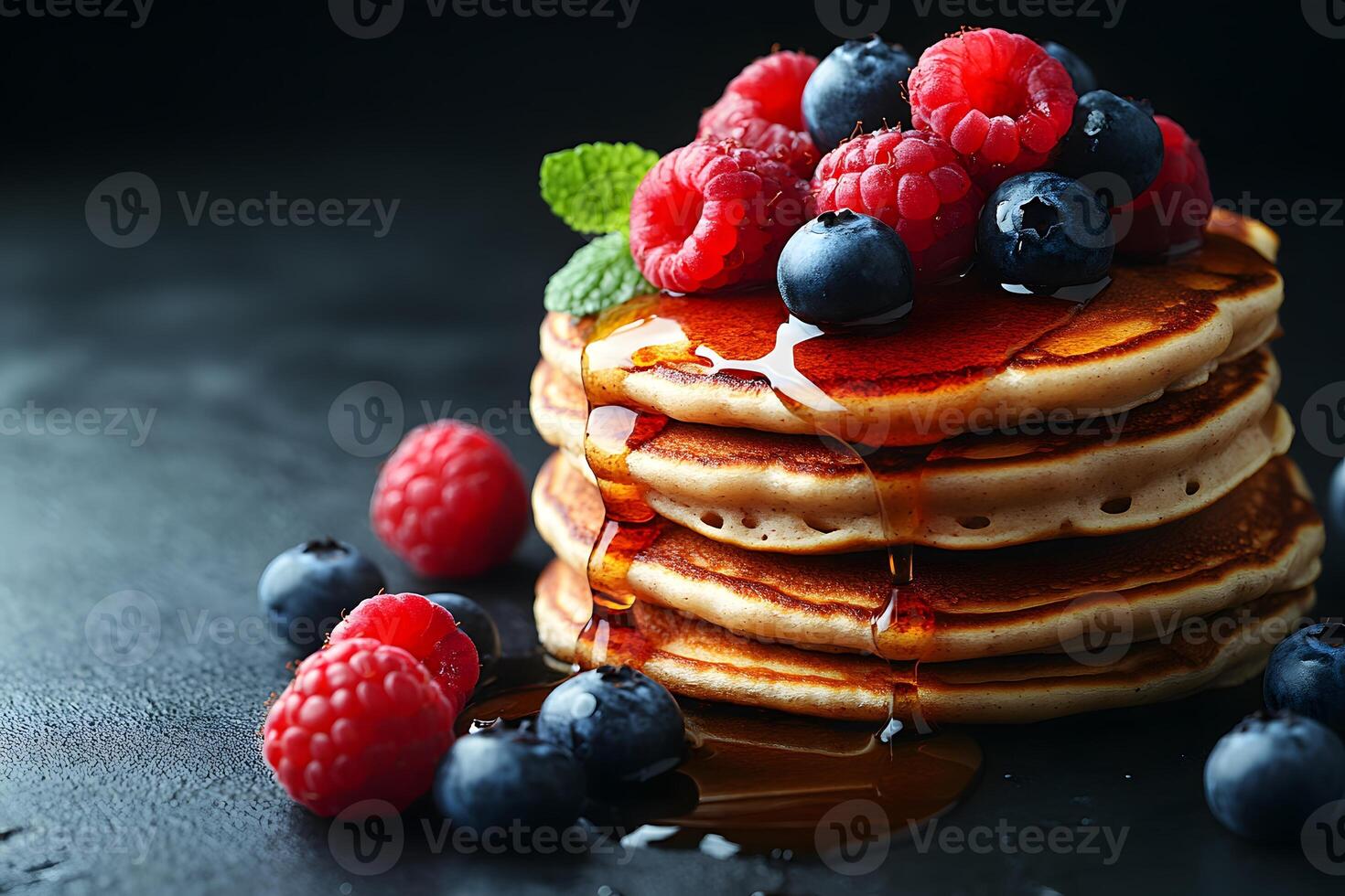 Stack of Blueberry and Raspberry Pancakes Topped with Fresh Berries and Maple Syrup photo
