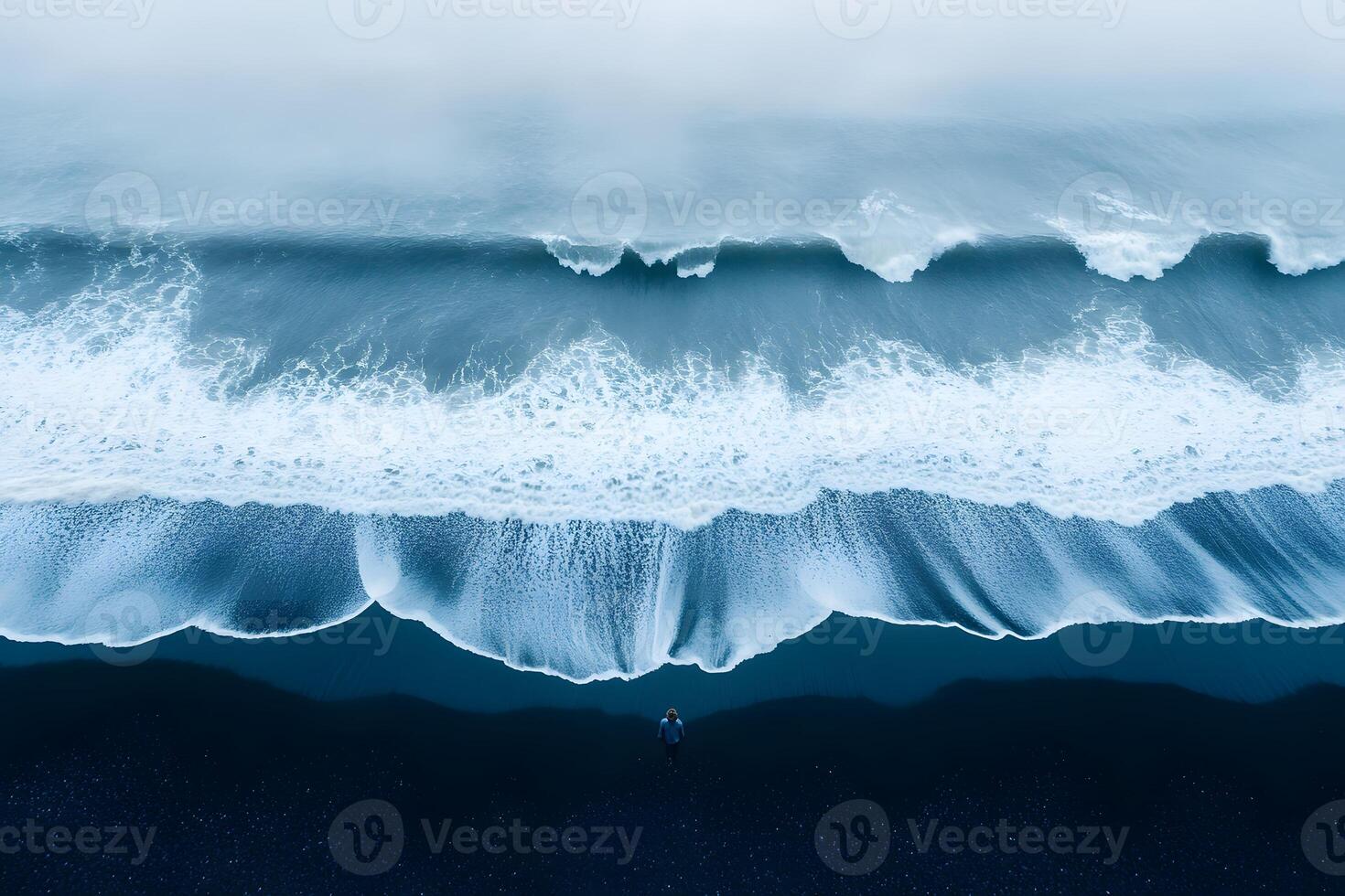 Serene Coastal View of Expansive Waves and Black Sand Beach from Above photo