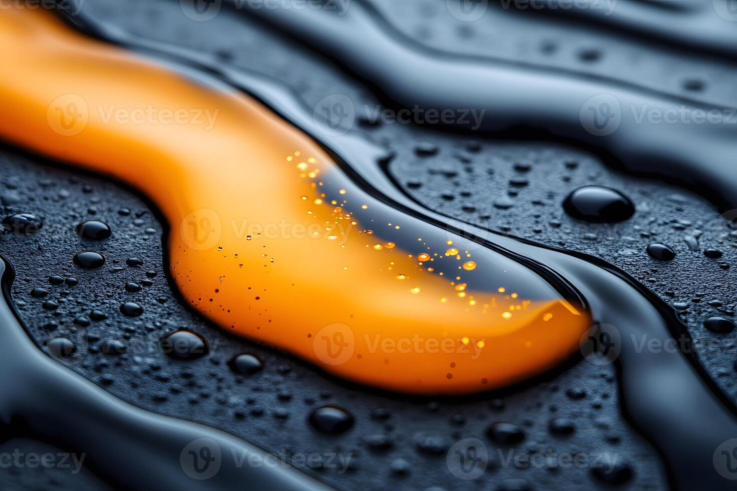 Close-Up of Vibrant Orange Liquid Stream on Textured Black Surface for Creative Backgrounds photo