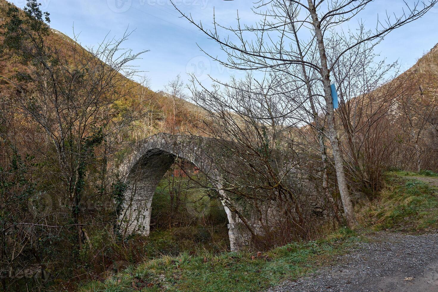 scenic view of the old stone bridge crossing the dobra river in asturias, spain photo