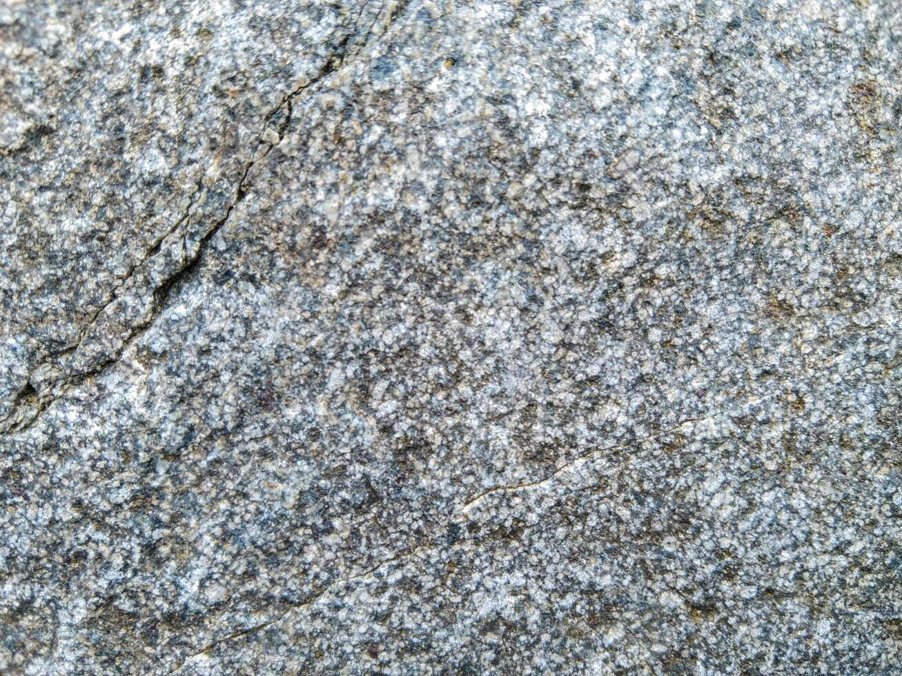 A close up of a gray stone surface photo