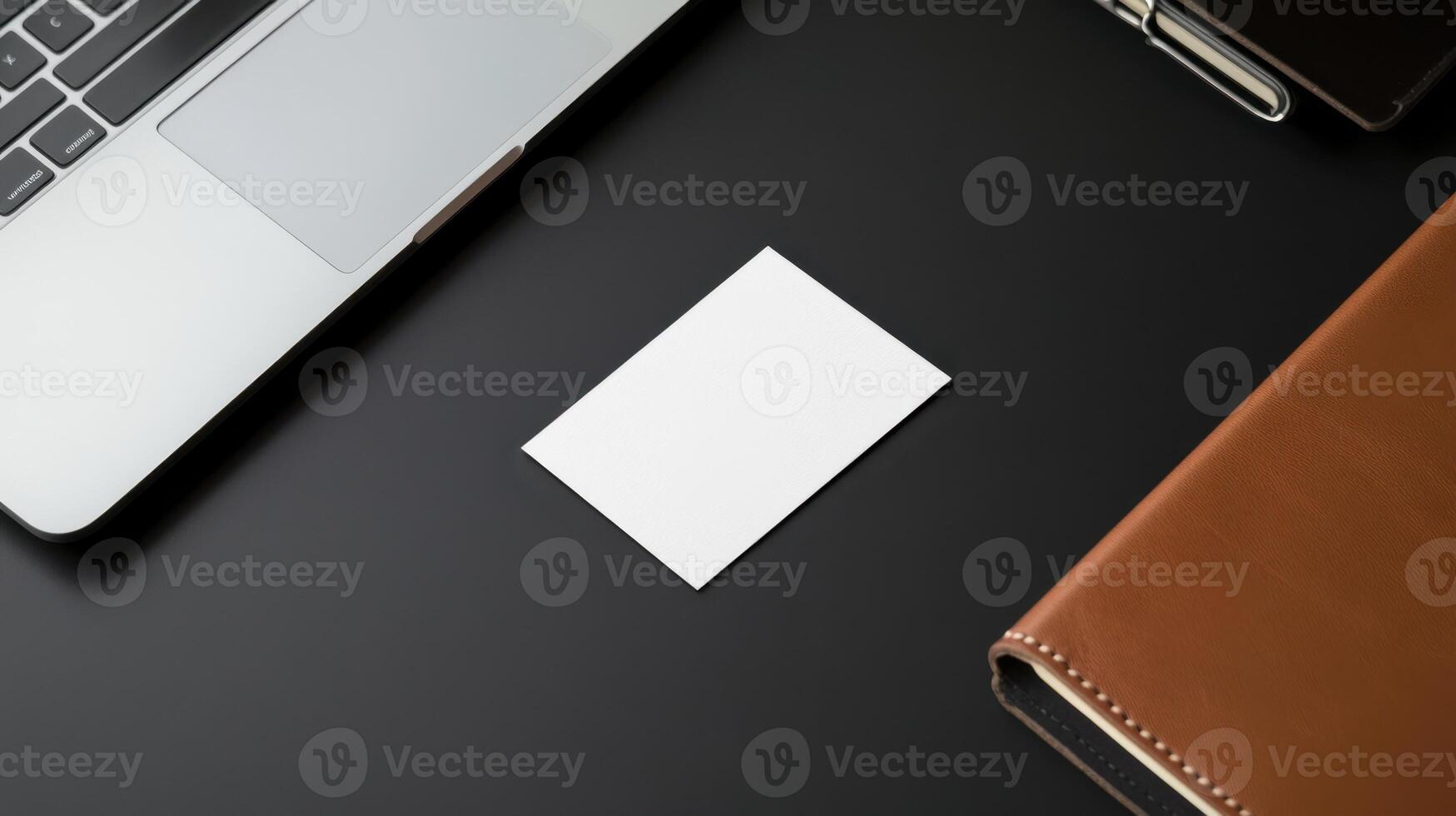 blank business card on sleek black desk with laptop and notebook photo