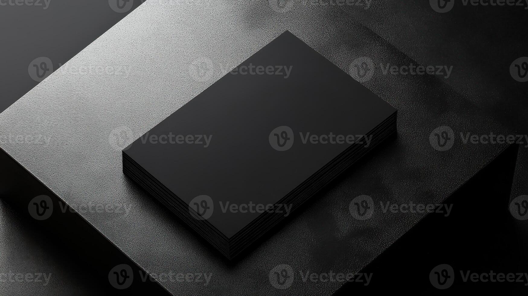 Minimalist black business cards stacked on textured surface photo