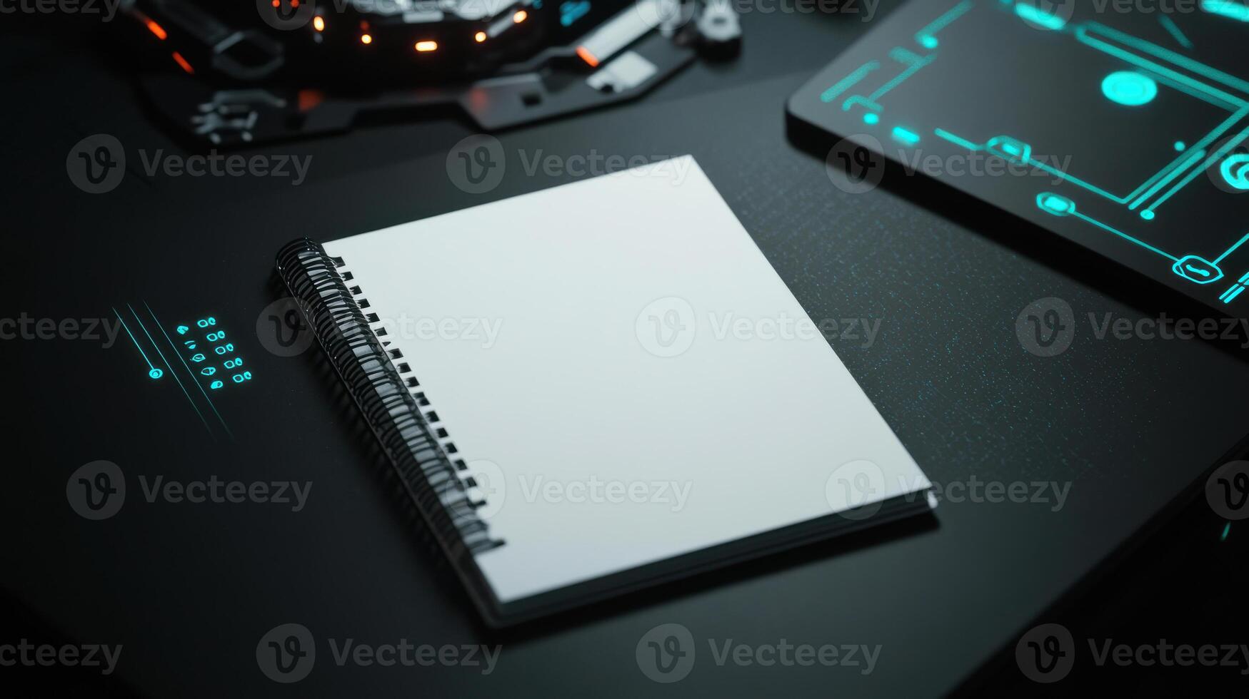 A blank notebook on a desk with a tablet and a computer photo