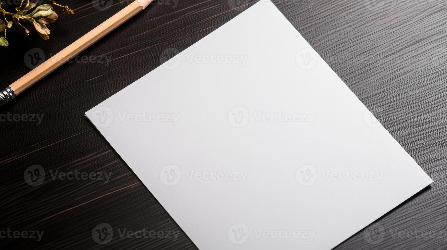 Blank paper on a wooden table with pencil and flowers photo