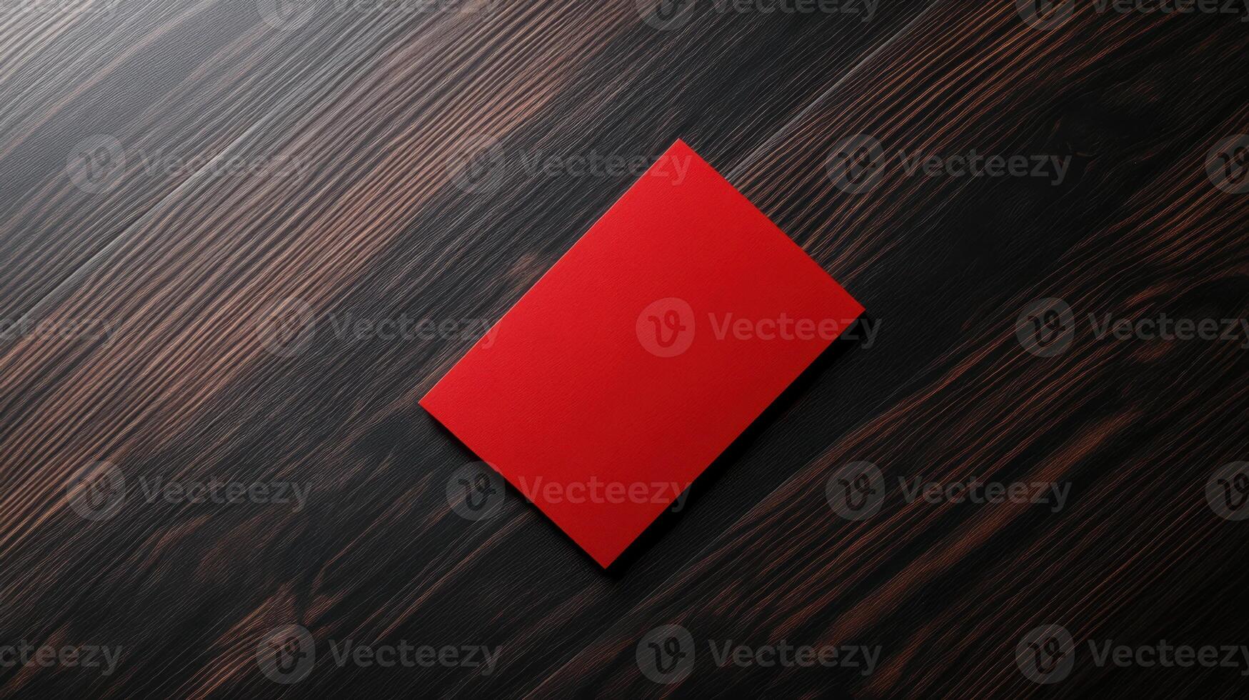 bold red card on dark wooden surface, creating striking contrast photo