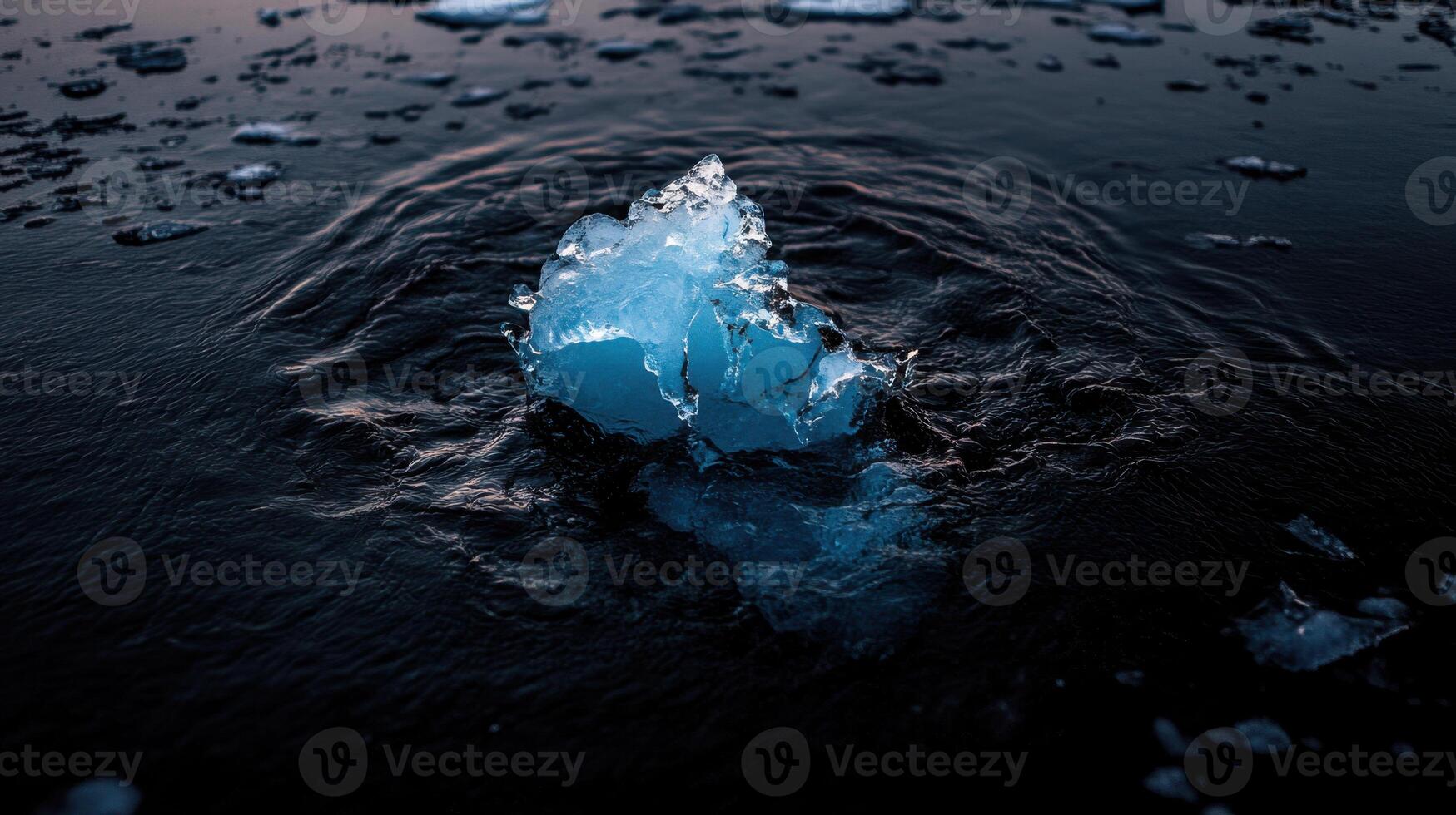 cracked iceberg floating in dark water, surrounded by melting ice photo