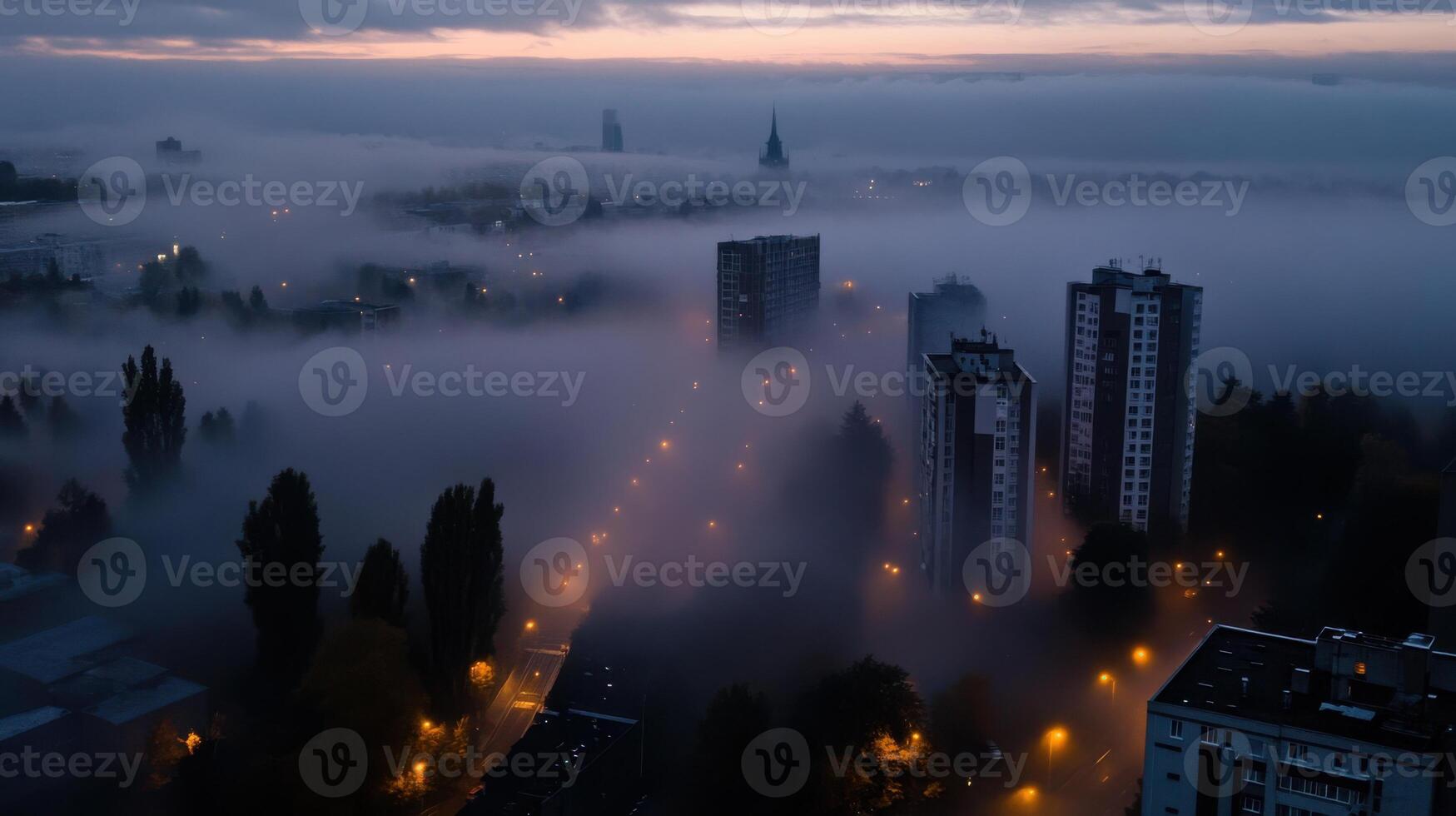 Foggy cityscape at dusk with buildings and trees photo