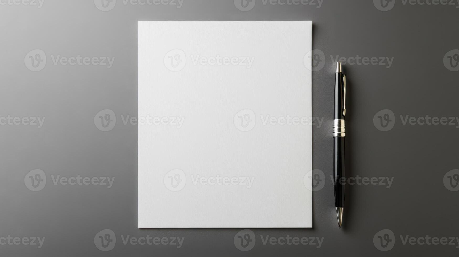 Blank paper with pen on grey background photo